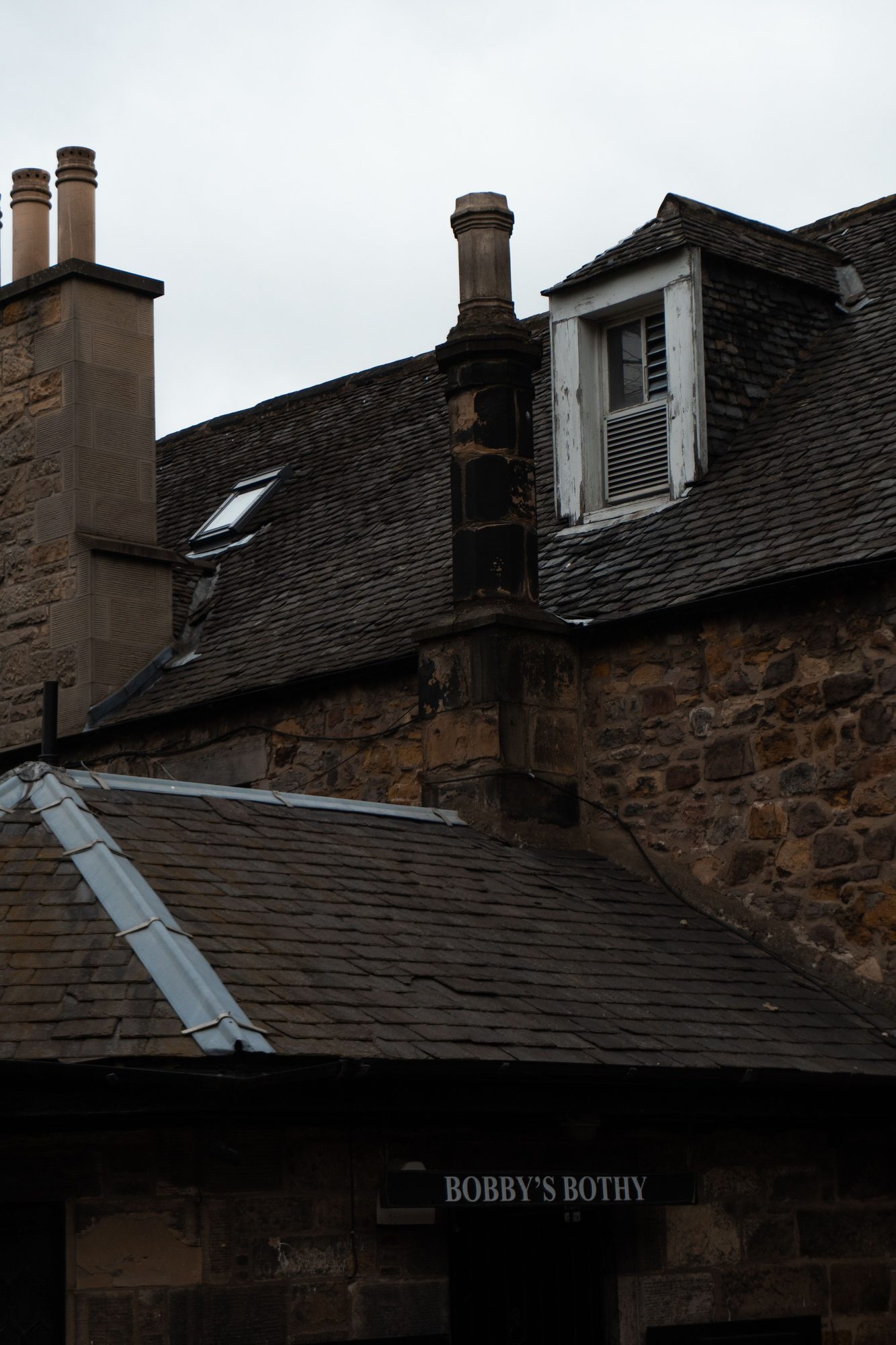 Bobby's Bothy, an Old Town Edinburgh rubble stone building with a slate roof, dormer window and skylight